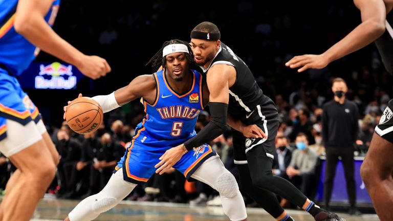 Oklahoma City Thunder forward Luguentz Dort (5) dribbles against aBrooklyn Nets center Day&#39;Ron Sharpe (20) during the first half of an NBA basketball game, Thursday, Jan. 13, 2022, in New York. (AP Photo/Jessie Alcheh)


