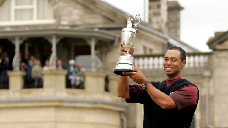 FILE - A July 17, 2005, file photo, Tiger Woods, of the United States, holds up the Claret Jub as he stands in front of the clubhouse after winning the British Open golf championship on the Old Course at St. Andrews, Scotland. (AP Photo/Alastair Grant, File)