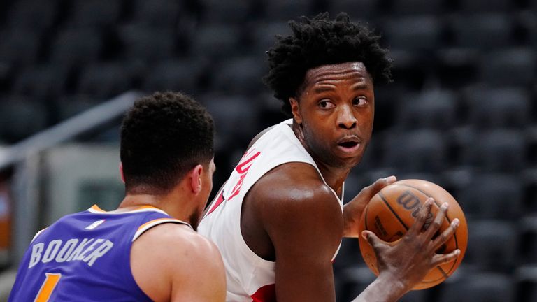 Toronto Raptors forward OG Anunoby (3) looks for a lane as Phoenix Suns guard Devin Booker (1) defends during the second half of an NBA basketball in Toronto on Tuesday, Jan. 11, 2022. (Frank Gunn/The Canadian Press via AP)