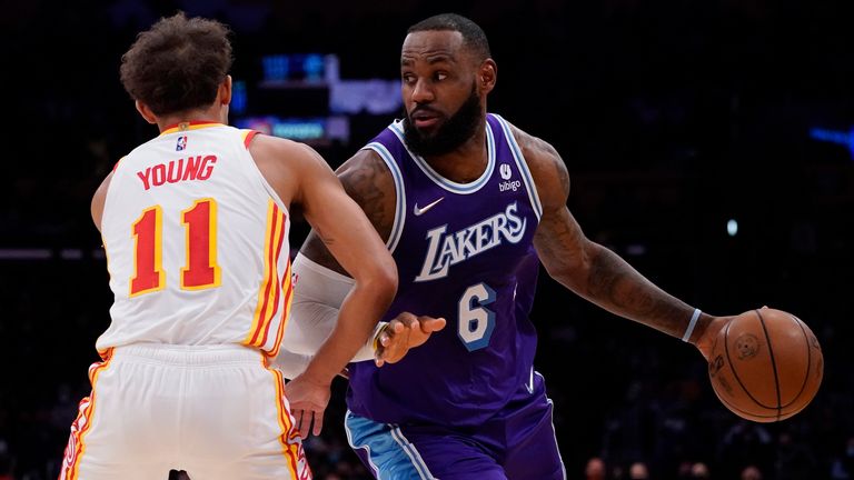 Atlanta Hawks goalie Trae Young defends against Los Angeles Lakers forward LeBron James