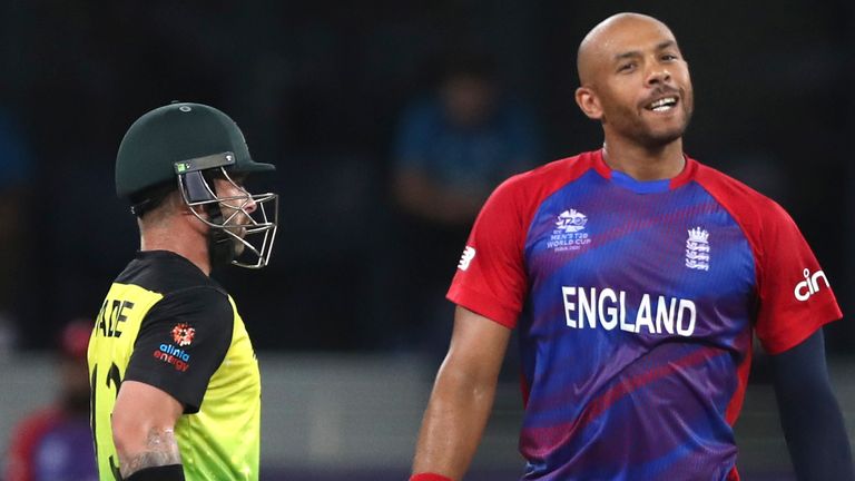 England's Tymal Mills, right, reacts after Australia's Matthew Wade, left hits a boundary during the Cricket Twenty20 World Cup match between Australia and England in Dubai, UAE, Saturday, Oct. 30, 2021. (AP Photo/Aijaz Rahi)..