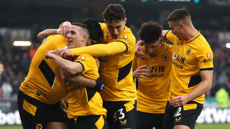 Raul Jimenez is mobbed by team-mates after scoring Wolves' opener from the penalty spot