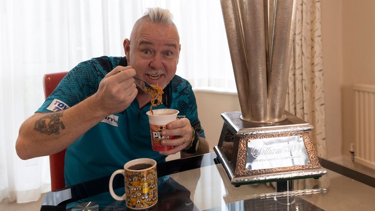 WILLIAM HILL WORLD DARTS CHAMPIONSHIP 2022.GOLDERS GREEN,.LONDON.PIC;LAWRENCE LUSTIG.THE MORNING AFTER THE NIGHT BEFORE.NEWLY CROWNED WORLD CHAMPION PETER WRIGHT  CELEBRATES HIS VICTORY WITH A POT NOODLE AND CUP OF BLACK TEA