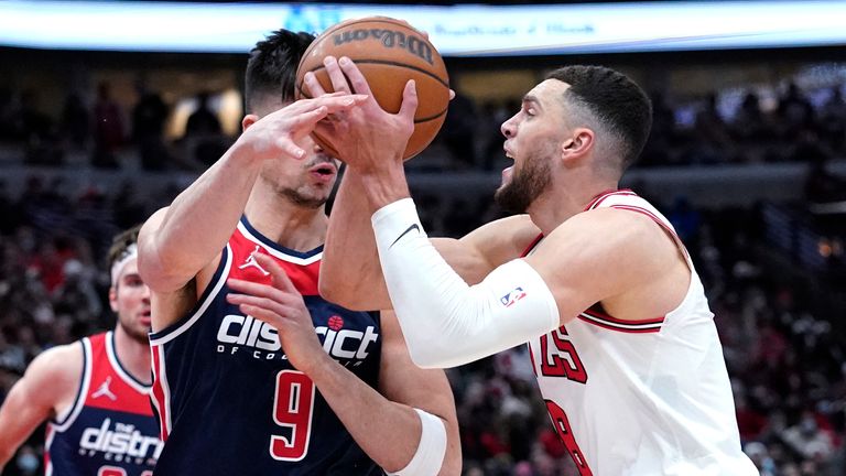 Chicago Bulls guard Zach LaVine, right, drives to the basket against Washington Wizards forward Deni Avdija during the second half of an NBA basketball game in Chicago, Friday, Jan. 7, 2022. (AP Photo/Nam Y. Huh)