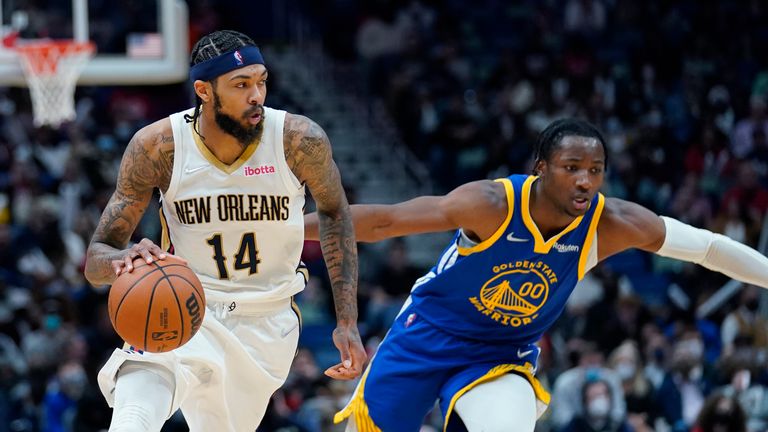New Orleans Pelicans forward Brandon Ingram (14) drives to the basket against Golden State Warriors forward Jonathan Kuminga (00) in the second half of an NBA basketball game in New Orleans, Thursday, Jan. 6, 2022. The Pelicans won 101-96. 