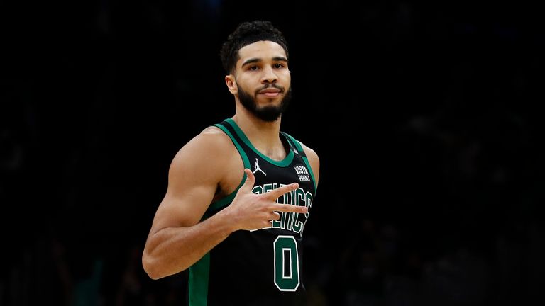 Boston Celtics&#39; Jayson Tatum holds up three fingers after making a 3-point basket against the Atlanta Hawks during the second half of an NBA basketball game Sunday,