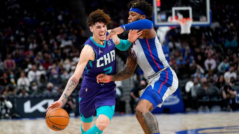Charlotte Hornets guard LaMelo Ball drives on Detroit Pistons forward Saddiq Bey in the first half of an NBA basketball game in Detroit, Friday, Feb. 11, 2022. 