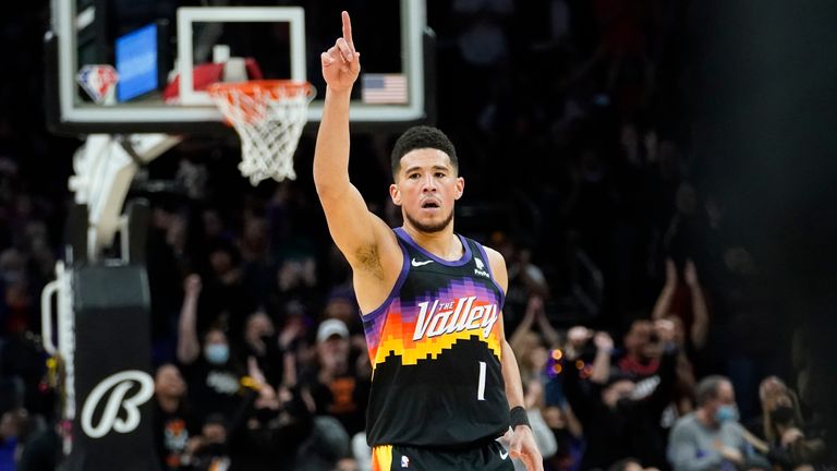 Phoenix Suns guard Devin Booker (1) celebrates a basket against the San Antonio Spurs during the second half of an NBA basketball game, Sunday, Jan. 30, 2022, in Phoenix. The Suns defeated the Spurs 115-110.