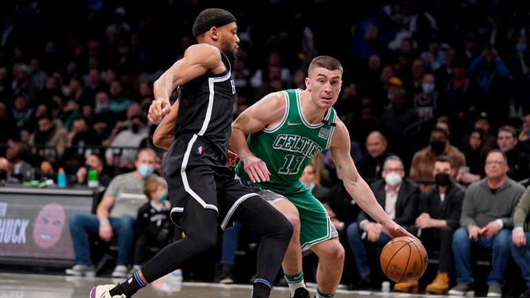 Boston Celtics guard Payton Pritchard drives against Brooklyn Nets forward Bruce Brown 