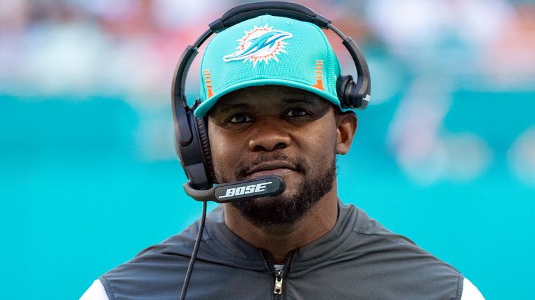 Miami Dolphins head coach Brian Flores smiles on the sidelines during an NFL football game against the Carolina Panthers, Sunday, Nov. 28, 2021, in Miami Gardens, Fla. (AP Photo/Doug Murray)