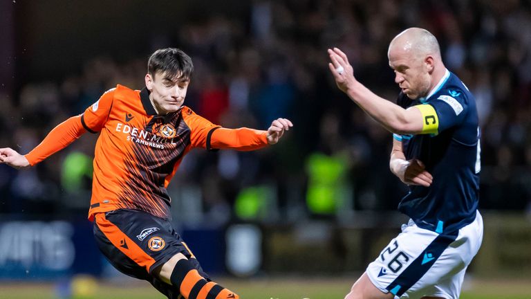 Dundee Utd's Dylan Levitt has a shot under pressure from Charlie Adam