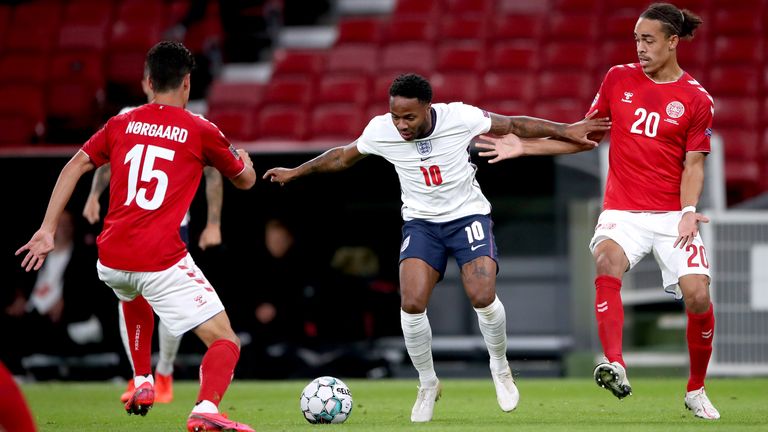 England's Raheem Sterling tries to beat Christian Norgaard and Yussuf Poulsen of Denmark