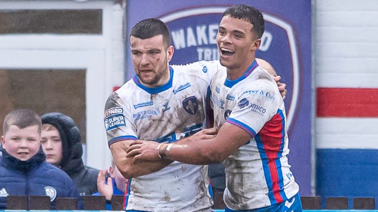 Wakefield's Corey Hall (r) is congratulated on scoring a try against Hull FC 