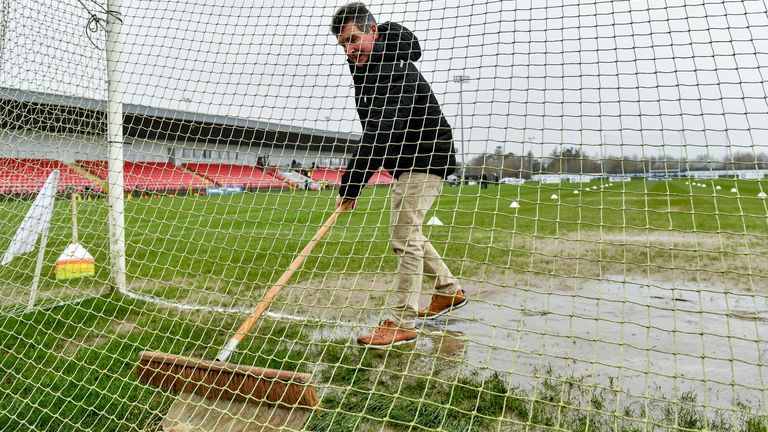 20 February 2022; Groundsman Colum McNicholl clears water from ther goal mouth before the Allianz Football League Division 2 match between Derry and Cork at Derry GAA Centre of Excellence in Owenbeg, Derry. Photo by Sam Barnes/Sportsfile