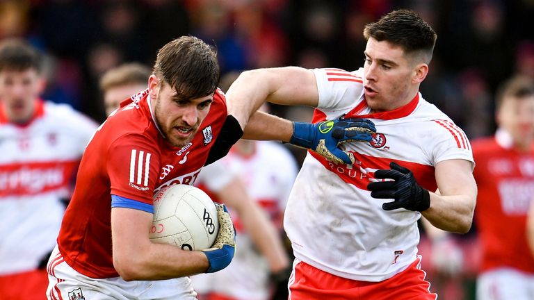 Ian Maguire of Cork is tackled by Conor Doherty of Derry