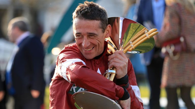 Jockey Davy Russell celebrates with the trophy after winning the Randox Health Grand National with Tiger Roll