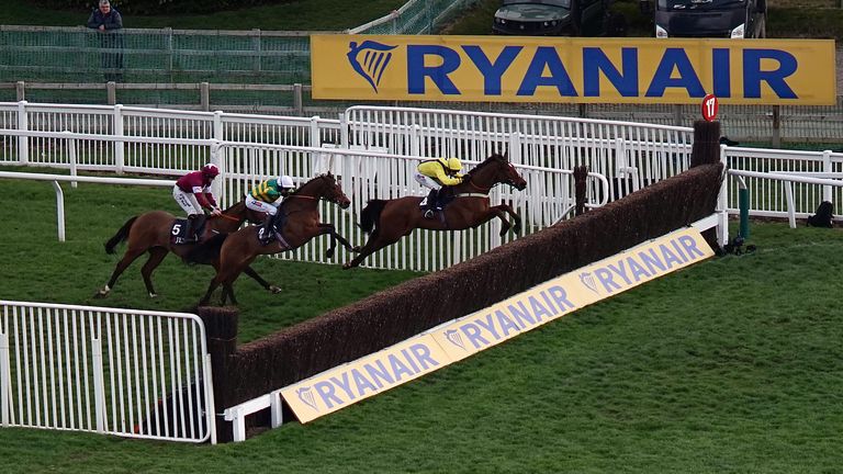 Defi Du Seuil (white cap) lets fly with a huge leap on his way to beating Lostintranslation in the JLT Novices' Chase at Cheltenham