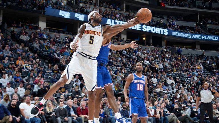 Denver Nuggets forward Will Barton reaches for a rebound as New York Knicks forward Jericho Sims defends 