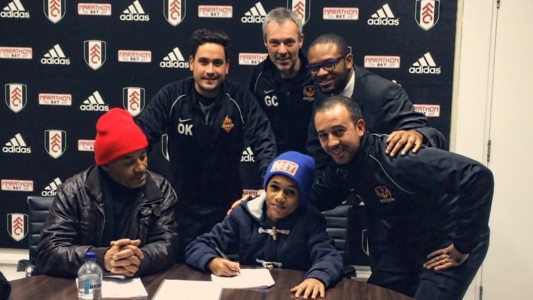 Fabio Carvalho signs for Fulham alongside Balham coaches Ollie Kanner (second left), Greg Cruttwell (centre) and Pedro Soares (bottom right)
