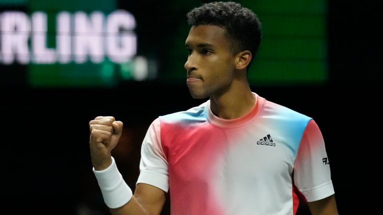 Felix Auger-Aliassime of Canada clenches his fist after winning the first set against Cameron Norrie of Britain in their quarterfinal men's singles match of the ABN AMRO world tennis tournament at Ahoy Arena in Rotterdam, Netherlands, Friday, Feb. 11, 2022. (AP Photo/Peter Dejong)
