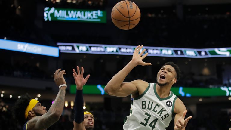 Milwaukee Bucks&#39; Giannis Antetokounmpo (34) loses control of the ball after being fouled against Indiana Pacers&#39; Oshae Brissett and Buddy Hield during the second half of an NBA basketball game Tuesday, Feb. 15, 2022, in Milwaukee.