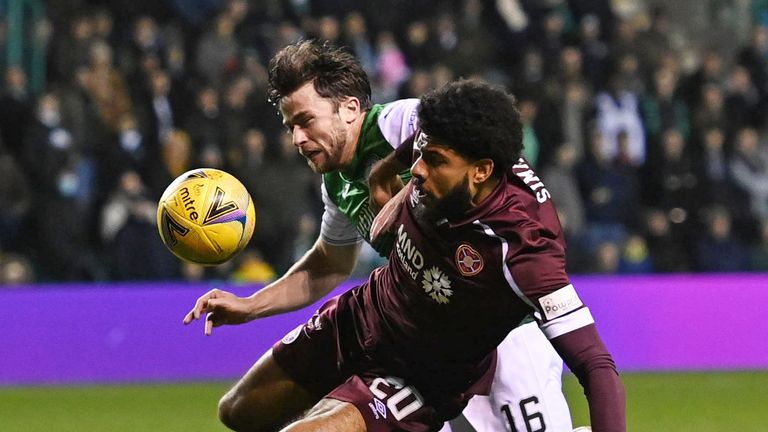 Hibs Lewis Stevenson (left) battles with Hearts' Ellis Simms but no penalty is given 