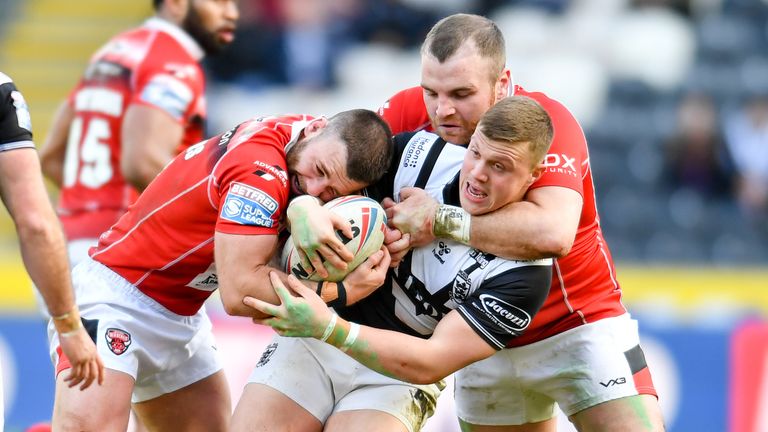 Picture by Will Palmer/SWpix.com - 26/02/2022 - Rugby League - Betfred Super League - Hull FC v Salford Red Devils - MKM Stadium, Kingston upon Hull, England - Jack Brown of Hull FC is tackled by Andy Ackers, Greg Burke and Elijah Taylor of Salford Red Devils