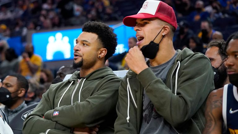 Jamal Murray, left, and Michael Porter Jr. pictured on the sidelines watching the Denver Nuggets