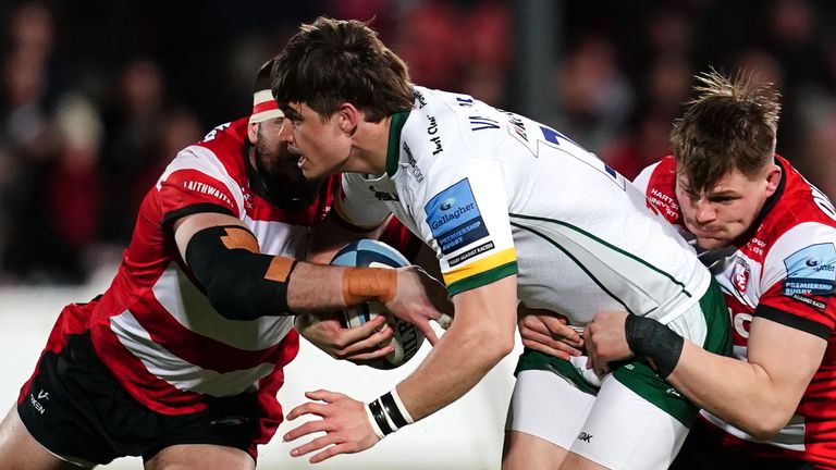 London Irish's Benhard Janse van Rensburg (centre) tackled by Gloucester Rugby's Lewis Ludlow and Freddie Clarke during the Gallagher Premiership match at the Kingsholm Stadium, Gloucester. Picture date: Friday February 4, 2022.