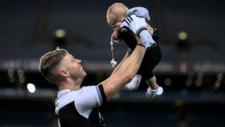 12 February 2022; Jerome Johnston of Kilcoo celebrates with his 5-month-old son Lar after the AIB GAA Football All-Ireland Senior Club Championship Final match between Kilcoo, Down, and Kilmacud Crokes, Dublin, at Croke Park in Dublin. Photo by Stephen McCarthy/Sportsfile