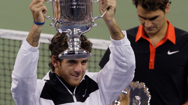Juan Martin del Potro, of Argentina, holds up the championship trophy after winning the men's finals championship over Roger Federer, right, of Switzerland, at the U.S. Open tennis tournament in New York, Monday, Sept. 14, 2009. (AP Photo/Elise Amendola)