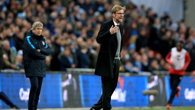 Liverpool manager Jurgen Klopp shouts instructions to his team as Manchester City manager Manuel Pellegrini (left) looks on behind during the 2016 EFL Cup final at Wembley Stadium, London.