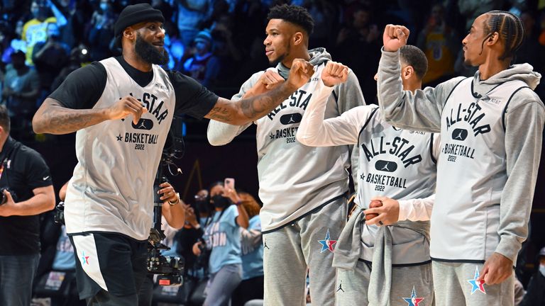 LeBron James fist-bumps with members of Team LeBron at NBA All-Star practice on Saturday