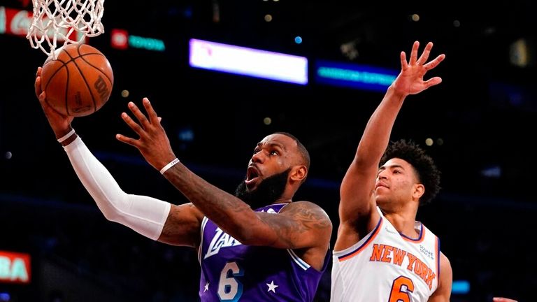 Los Angeles Lakers forward LeBron Jame, left, shoots as  guard Quentin Grimes defends during the first half of an NBA basketball game Saturday, Feb. 5, 2022, in Los Angeles. (AP Photo/Mark J. Terrill)