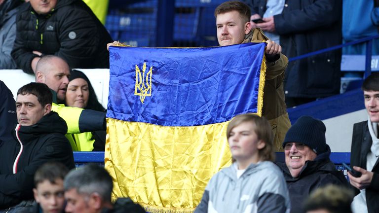 A fan holds up a flag in support of Ukraine before the Premier League match at Goodison Park,