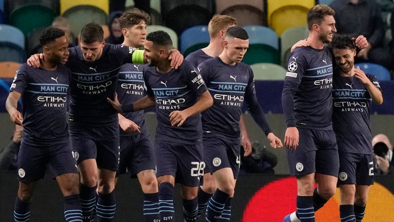 Manchester City players celebrate the second goal of their team during the Champions League round of 16 match between Sporting CP and Manchester City at the Alvalade stadium in Lisbon, Portugal