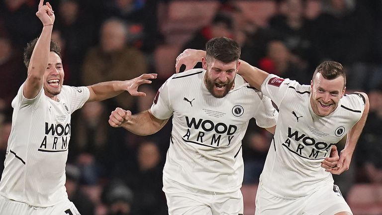 Boreham Wood's Mark Ricketts (right) celebrates his opener with teammates