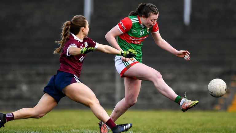 27 February 2022; Sinead Walsh of Mayo scores her side's sixth goal despite the attention of Aoife N.. Cheallaigh of Galway during the Lidl Ladies Football National League Division 1 match between Galway and Mayo at Tuam Stadium in Galway. Photo by Ben McShane/Sportsfile 