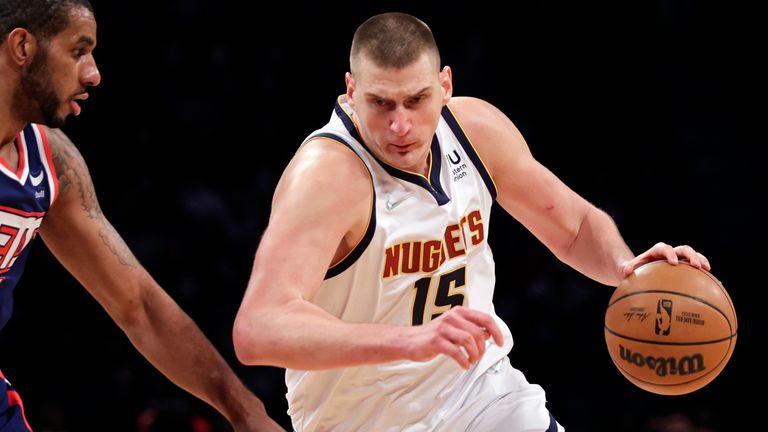 Denver Nuggets center Nikola Jokic (15) drives past Brooklyn Nets center LaMarcus Aldridge during the first half of an NBA basketball game Wednesday, Jan. 26, 2022, in New York.  The Nuggets won 124-118.  (
