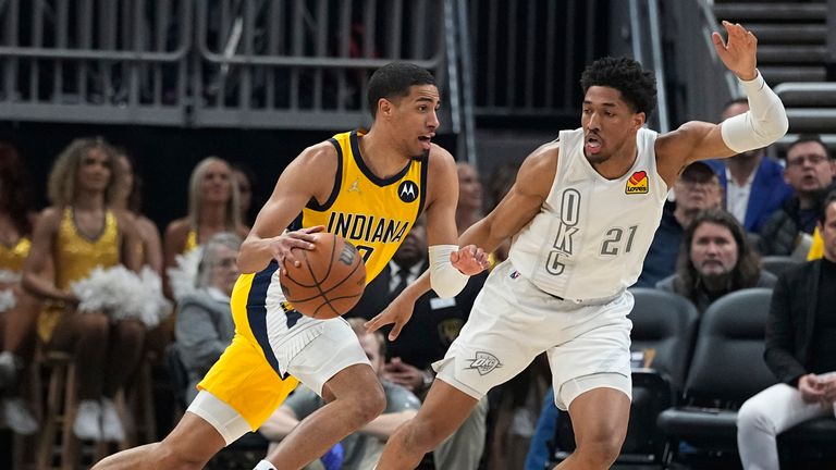 Indiana Pacers&#39; Tyrese Haliburton goes to the basket against Oklahoma City Thunder&#39;s Aaron Wiggins during the first half of an NBA basketball game Friday, Feb. 25, 2022, in Indianapolis.