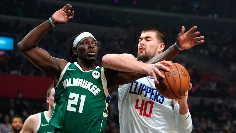 Los Angeles Clippers center Ivica Zubac, right, tries to shoot as Milwaukee Bucks guard Jrue Holiday defends during the first half of an NBA basketball game Sunday, Feb. 6, 2022, in Los Angeles.