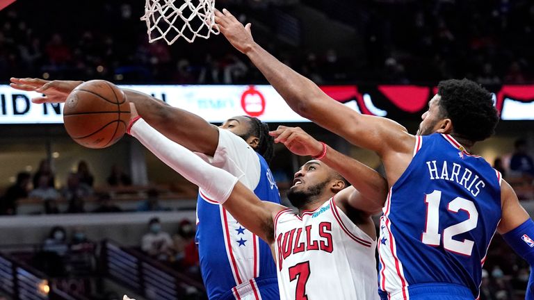Chicago Bulls forward Troy Brown Jr., (7) drives to the basket against Philadelphia 76ers center Andre Drummond and forward Tobias Harris, right, during the second half of an NBA basketball game in Chicag