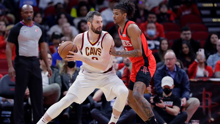 Cleveland Cavaliers forward Kevin Love looks to drive around Houston Rockets guard Jalen Green during the second half of an NBA basketball game
