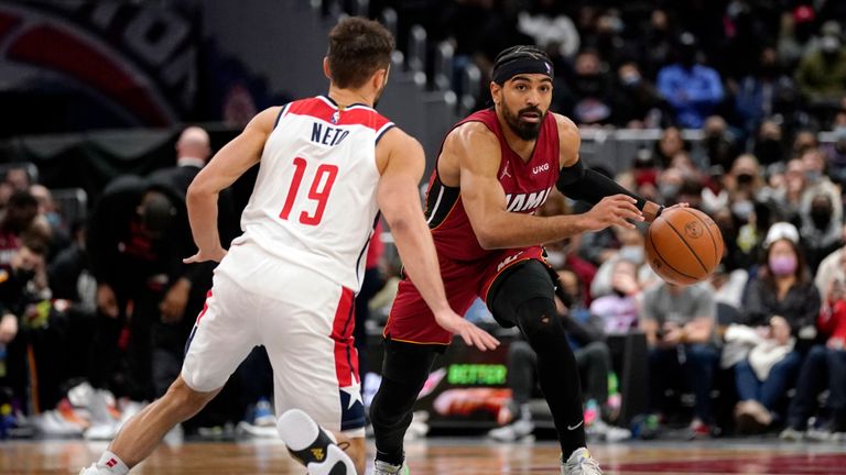Washington Wizards guard Raul Neto (19) defends Miami Heat guard Gabe Vincent (2) during the second half of an NBA basketball game, Monday, Feb. 7, 2022, in Washington. The Heat defeated the Wizards 121-100. (AP Photo/Evan Vucci) 