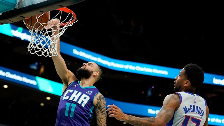 Charlotte Hornets forward Cody Martin scores past Detroit Pistons guard Rodney McGruder during the first half of an NBA basketball game on Sunday, Feb. 27, 2022, in Charlotte, N.C