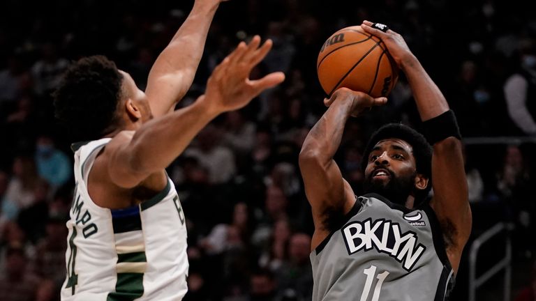 Brooklyn Nets&#39; Kyrie Irving shoots past Milwaukee Bucks&#39; Giannis Antetokounmpo during the first half of an NBA basketball game Saturday, Feb. 26, 2022, in Milwaukee.