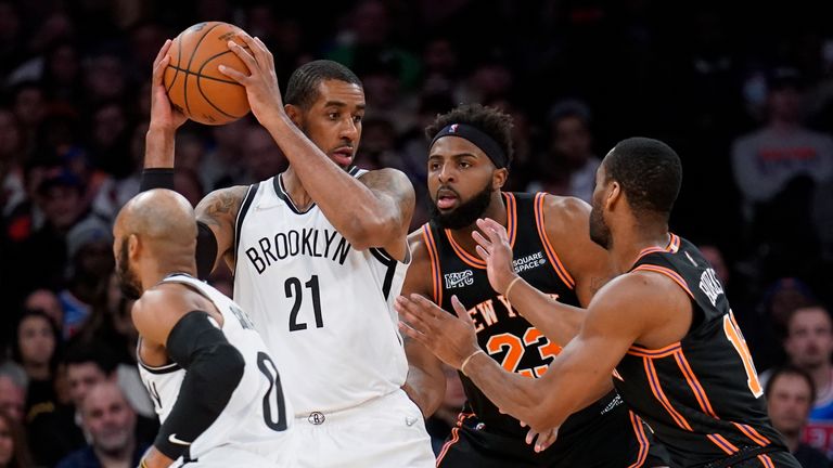 Brooklyn Nets center LaMarcus Aldridge (21) looks to pass against a double team of New York Knicks center Mitchell Robinson (23) and guard Alec Burks, right, during the second half of an NBA basketball game, Wednesday, Feb. 16, 2022, in New York