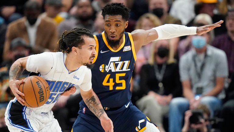 Utah Jazz guard Donovan Mitchell defends against Orlando Magic guard Cole Anthony during the first half during an NBA basketball game Friday, Feb. 11, 2022, in Salt Lake City.