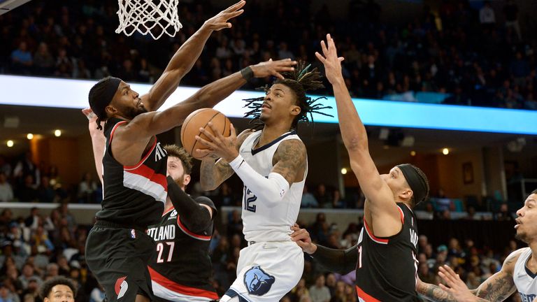 Memphis Grizzlies guard Ja Morant (12) shoots against Portland Trail Blazers forward Justise Winslow (26) and guard Josh Hart (11) in the second half of an NBA basketball game