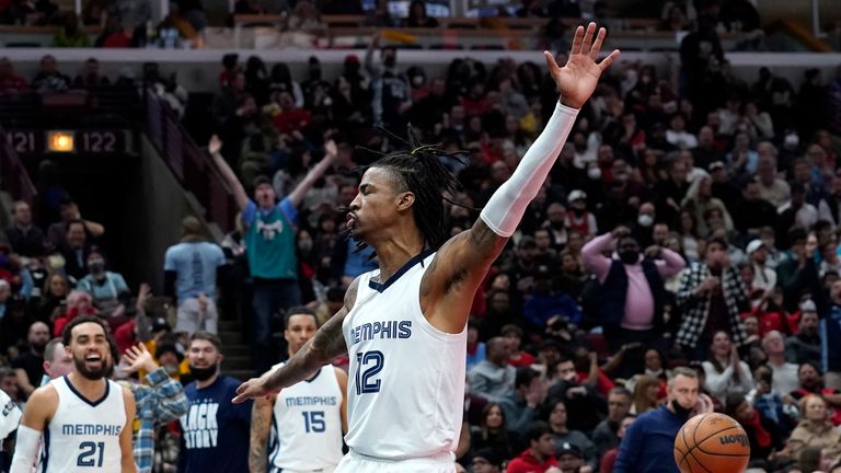 Memphis Grizzlies&#39; Ja Morant celebrate a big dunk during the second half of an NBA basketball game against the Chicago Bulls, Saturday, Feb. 26, 2022, in Chicago.
